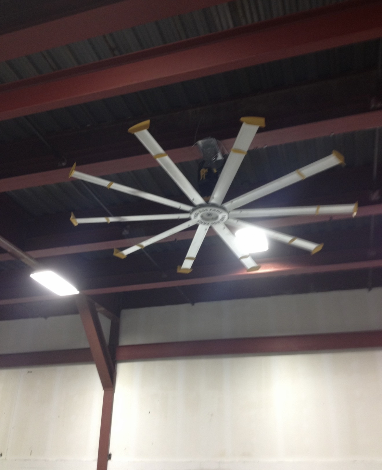 Large industrial HVLS ceiling fan installed in a commercial warehouse